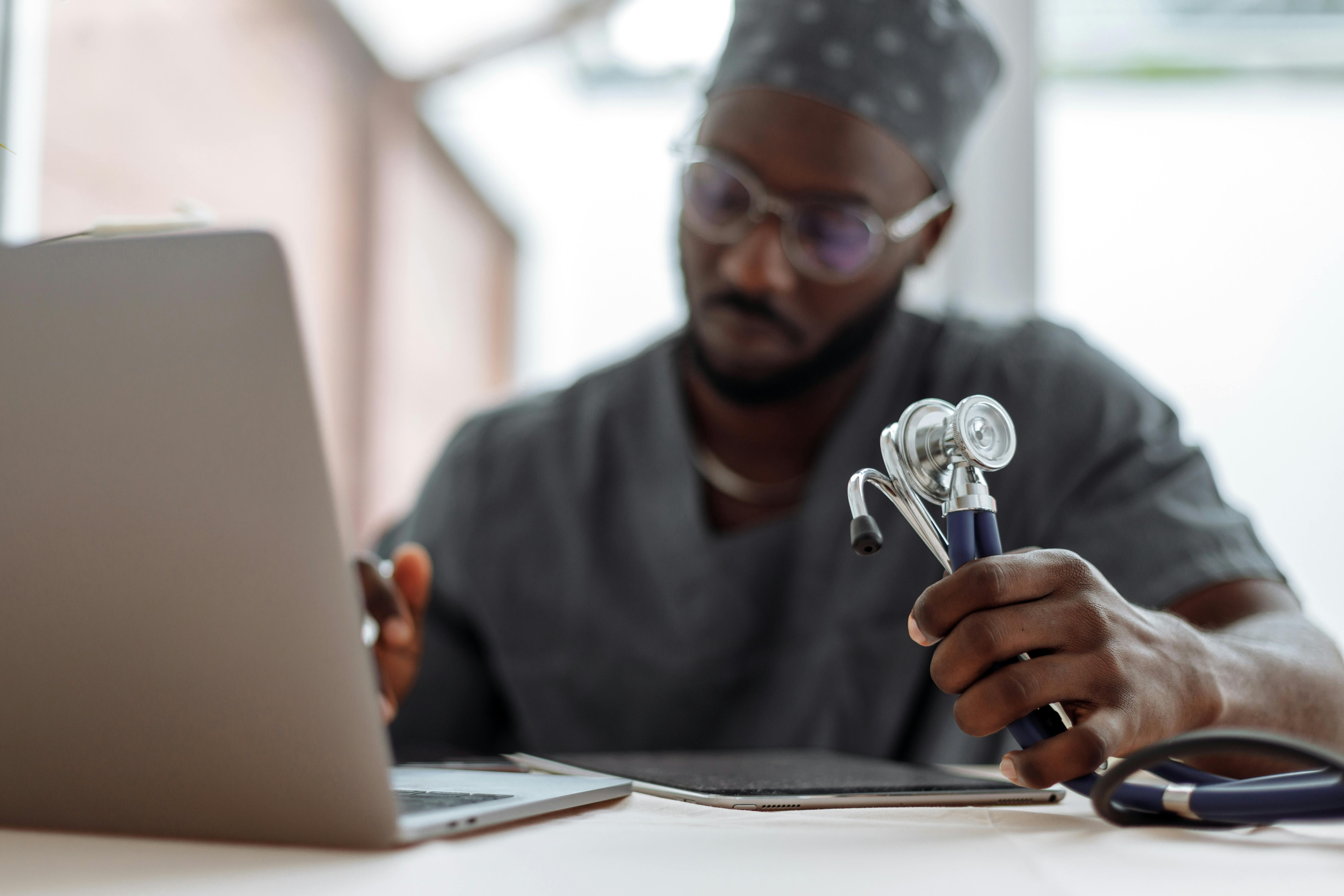 Image of a male doctor working on a laptop and iPad- First-Party Data in Healthcare Marketing blog featured image
